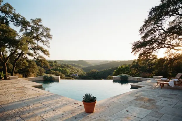 Hill Country pool in Austin with a limestone deck and a view over cedar-covered hills
