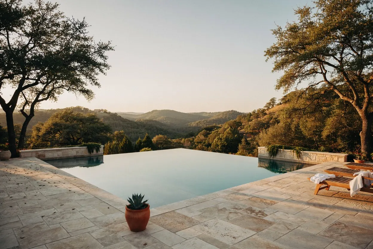Hill Country pool in Austin with a limestone deck and a view over cedar-covered hills