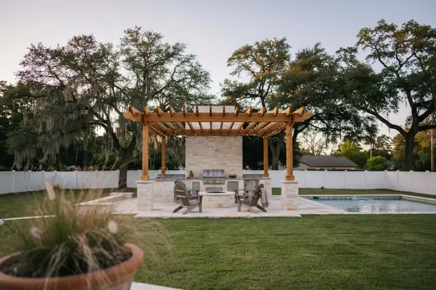 Texas backyard with pool, stone outdoor kitchen, fire pit and cedar pergola